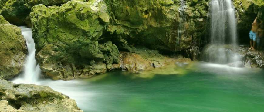 Clear freshwater spring in Loon, Bohol, surrounded by lush greenery and calm natural scenery